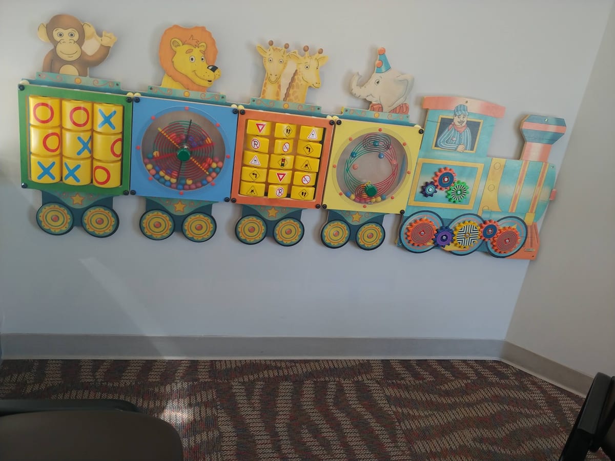 The children's activity wall in the All West Dental waiting room