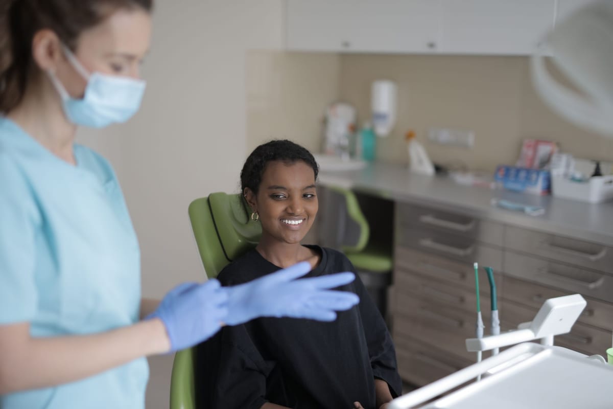 A clinician going through treatment options with a patient at the chairside screen