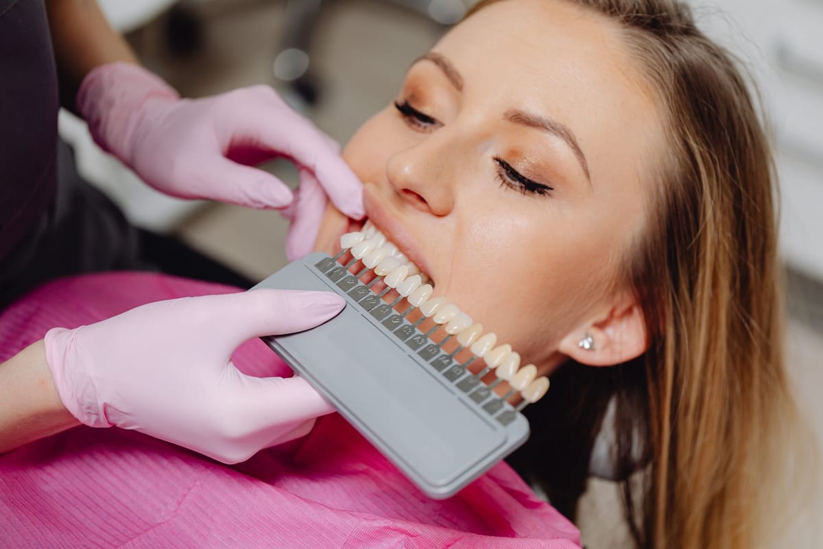 A dental team carrying out a procedure on a patient in the treatment chair